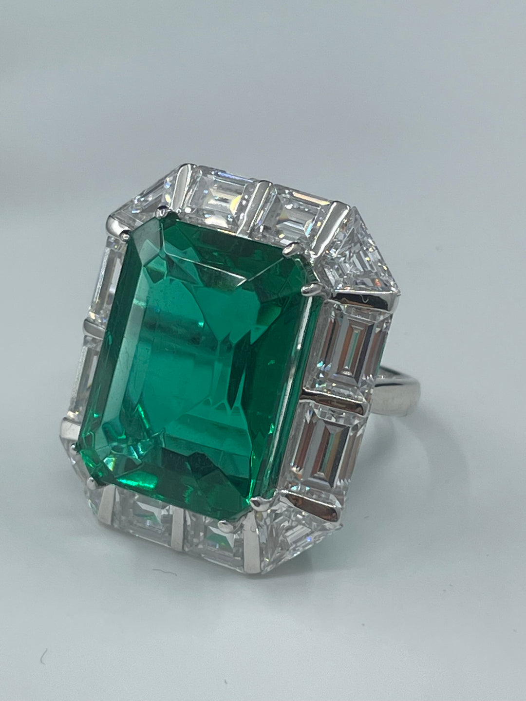 Green emerald ring with baguette  خاتم ايميرالد محاط بالباغيت